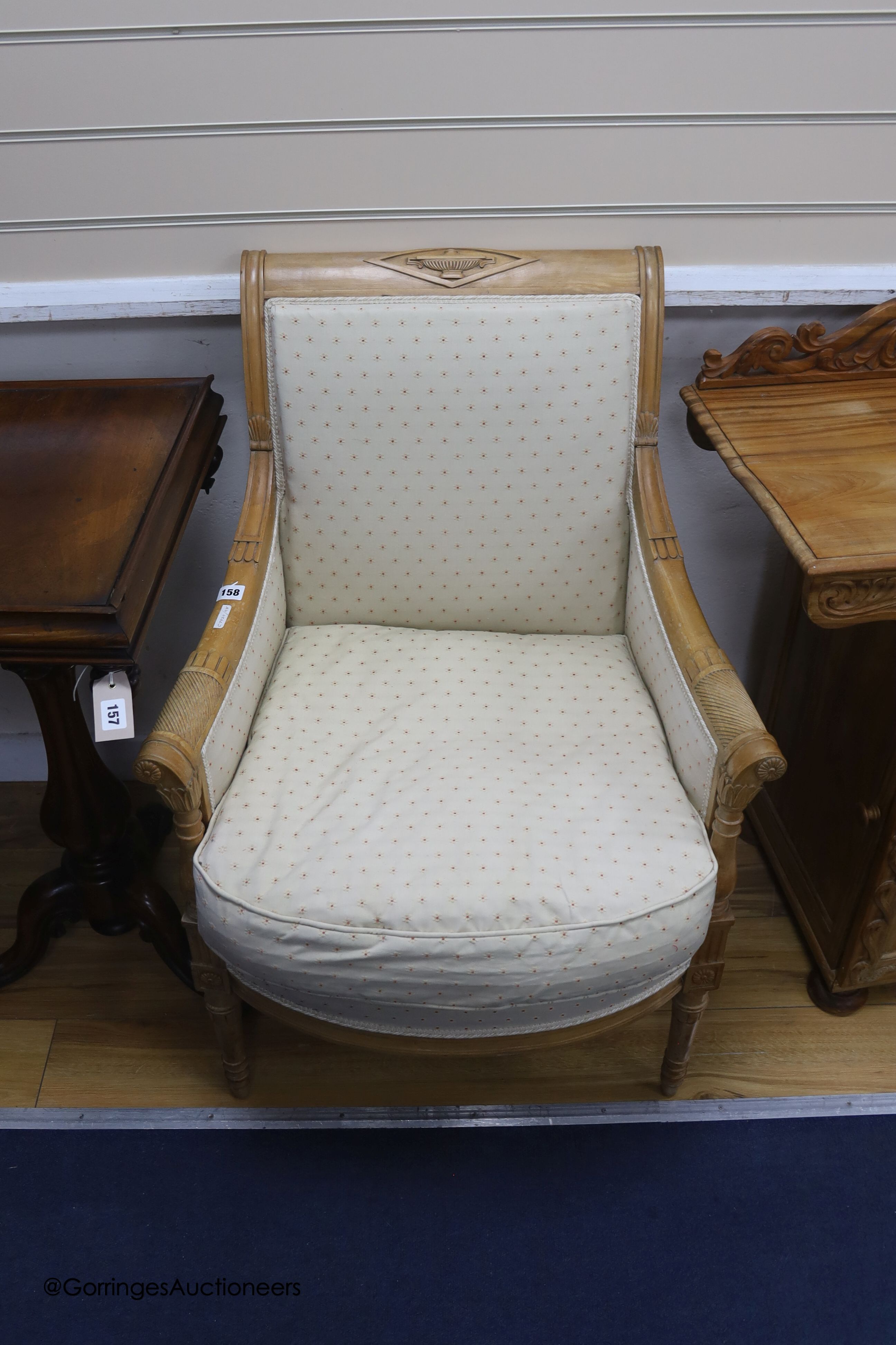 A 19th century Regency style carved beech bedroom armchair